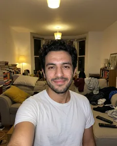 Input selfie: taken at arm's length in a living room